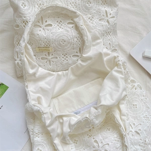 Detail shot of the white embroidery lace tote bag interior with zipper pocket and lining