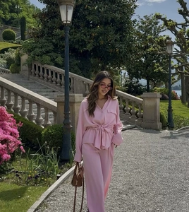 Close-up of pink long-sleeved shirt set with waist tie design and glossy fabric