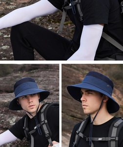 Detail of wide brim sun hat with mesh vents and matching white arm sleeves for hiking