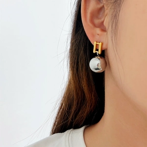 Modern French INS style earrings with gold studs and silver metallic spherical pendants
