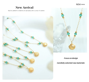 Detail of 18K gold plated necklace featuring green crystal beads and a shell pendant