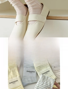 Close-up of soft striped cotton crew socks with beige Mary Jane flats in cream tones