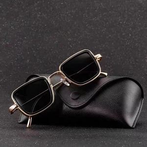 Retro square sunglasses with gold metal frame and dark lenses on a premium leather case