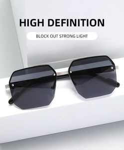 Detail of square pilot sunglasses featuring silver metal double bridge and dark lenses