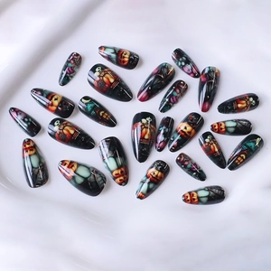 Halloween almond press-on nails featuring spooky pumpkin and haunted house art on white silk