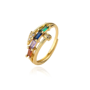 Detail of gold-plated nail ring with colorful rectangular zircons and pave crystals