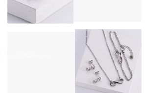 Detailed view of silver infinity pendant jewelry set with necklace bracelet and earrings