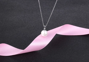 Detailed shot of S925 sterling silver pearl necklace with high-quality white shell pendant