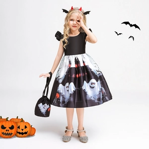 Detail of girls' Halloween ghost dress with castle print, devil horns, and pumpkin bag