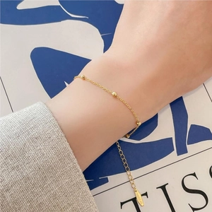 Elegant 925 sterling silver gold beaded bracelet worn on a female wrist for daily styling