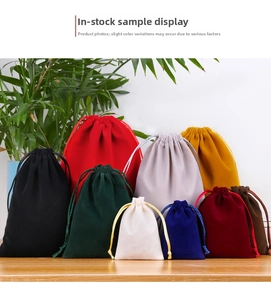 Multi-color velvet drawstring pouches displayed on a rustic wooden table background