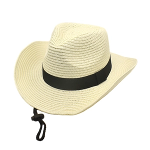 Detail of a beige woven cowboy hat showing a black decorative band and adjustable chin strap