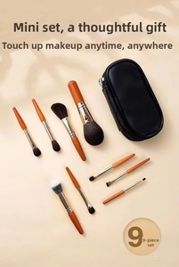 Detailed 9-piece portable makeup brush set with wooden handles and black leather case