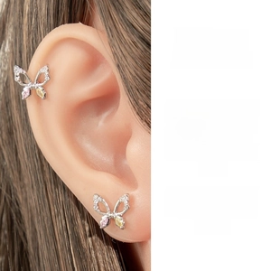 Detail of silver butterfly ear bone stud set with colorful cubic zirconia stones