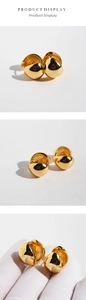 Detailed macro view of gold-plated chunky hoop earrings with high mirror finish texture