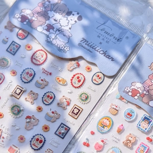 Detail of 3D embossed nail stickers featuring cute bears and cupcakes with pearl accents