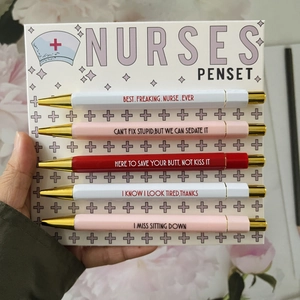 Close-up of nurse-themed 5-pack ballpoint pens set with funny quotes on paper backing