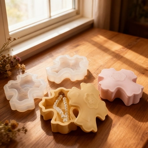 Macro detail of clover-shaped jewelry storage box mold showing embossed flower lid pattern