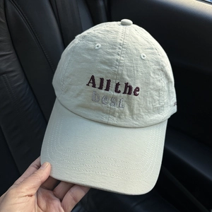 Detail of light khaki baseball cap with All the best embroidery and breathable fabric