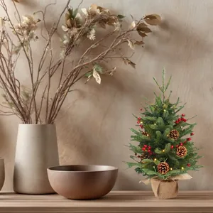 Mini Christmas tree with red berries, pine cones and LED lights in burlap base