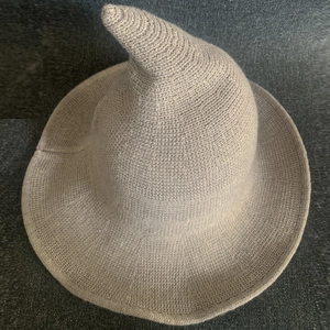 Close-up of knit witch hat showing chunky texture and pointed design in beige