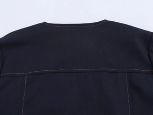 Close-up of contrast yellow stitching on the back of a navy cotton short sleeve top