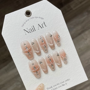 Cat-eye gradient press-on nails with rhinestones and pearls on coffin-shaped tips