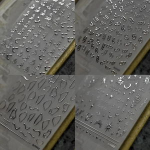Silver 3D laser nail stickers with metallic saturn star and moon designs on sheets