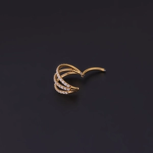 Detail of a triple-layered gold nose ring with finely inlaid sparkling cubic zirconia