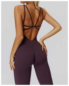 Detail of cross-back straps on deep purple yoga jumpsuit with an open-back design