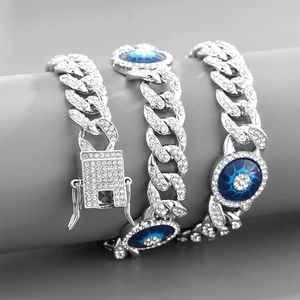 Iced out silver Cuban chain bracelet with blue evil eye charms and clear rhinestones