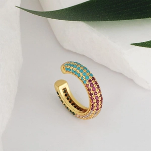 U-shaped gold-plated ear cuff with colorful cubic zirconia stones in a natural setting