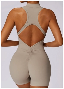 Detail view of tan racerback yoga jumpsuit featuring ruched back and cutout design