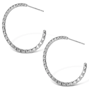 Macro view of silver stainless steel hoop earrings with 3D faceted texture details