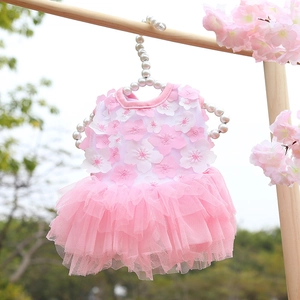 Detail of pink tiered mesh pet dress with 3D petals hanging on pearl hanger