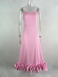 Detailed close-up of pink spaghetti strap dress with layered 3D ruffle hem texture