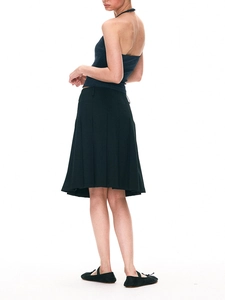 Detail of a black pleated midi skirt featuring fine knife pleats and an A-line silhouette