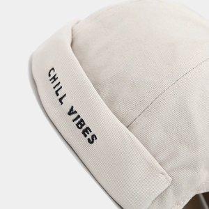 Beige cotton docker hat with Chill Vibes embroidery in a stylish minimalist urban design