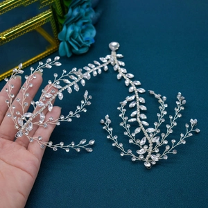 Detailed macro view of silver leaf-shaped bridal headpiece with sparkling crystals