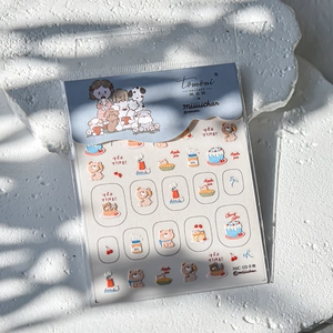 Detail of 3D embossed nail art stickers featuring cute cartoon bear and cake patterns