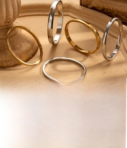 Detail of minimalist oval titanium steel bangles in gold and silver with vacuum plating