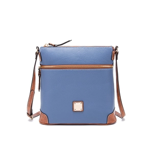 Detail showing deep blue pebble texture leather and brown contrast trim of the crossbody bag