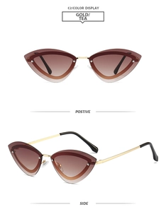 Detail view of cat eye rimless sunglasses with gold metal frame and brown gradient lenses