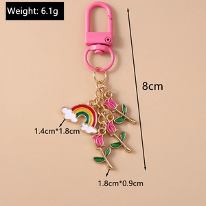 Close-up of pink rose charms and rainbow cloud keychain with dimensions and weight info