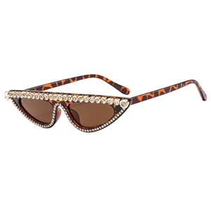 Chic cat-eye sunglasses with rhinestone edges and classic leopard print temples