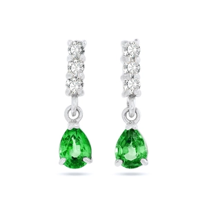 Close-up of pear-cut green emerald drop earrings with white zircon accents in silver setting