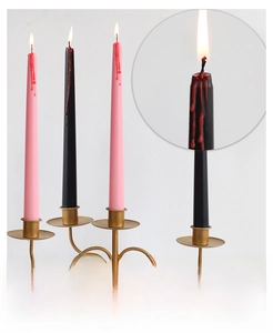 Detail view of Halloween taper candles with realistic red dripping blood effect on black wax
