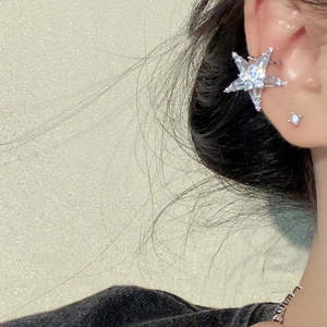 Elegant starfish-shaped silver stud earrings with sparkling cubic zirconia on female model