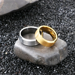 Polished tungsten steel rings in silver and gold colors with brushed metal texture