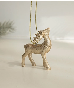 Detail of a gold glitter reindeer hanging ornament for a Nordic style Christmas tree